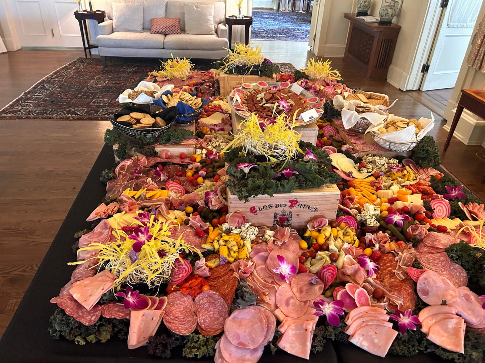 Artisan grazing table with meats, cheeses, and flowers