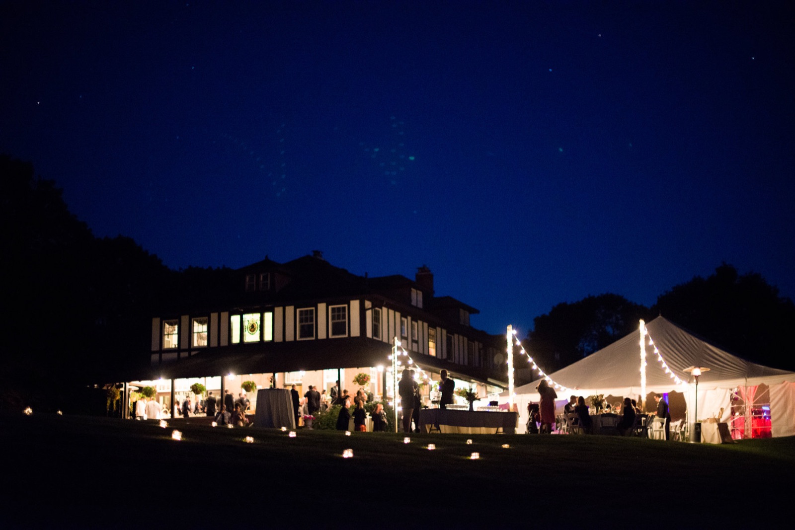 Wedding marquee tent glowing under the night sky