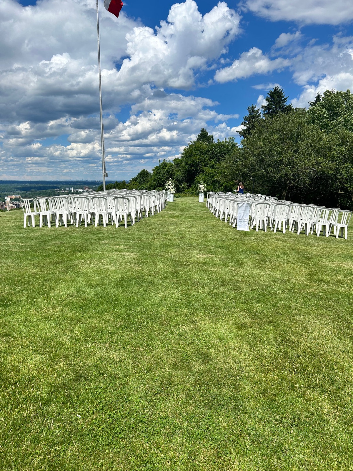Outdoor wedding ceremony on a lawn with a scenic view