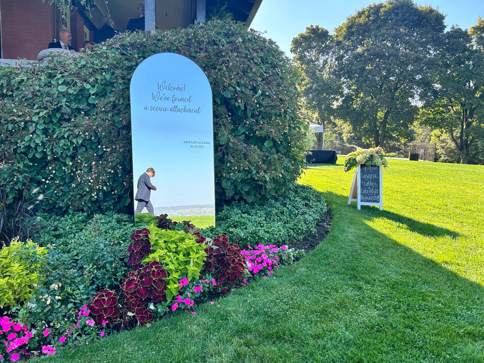 An arched welcome mirror in a garden